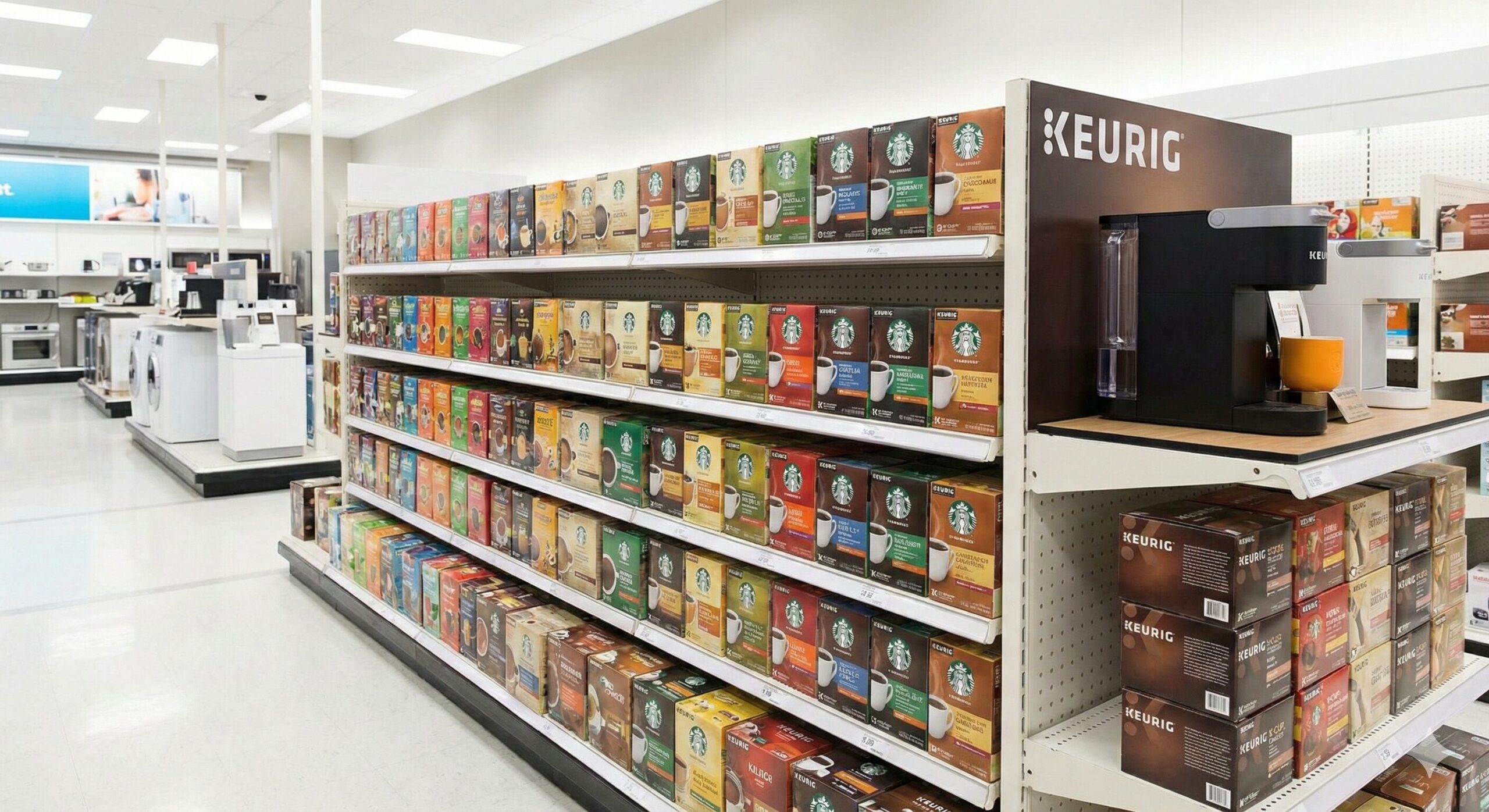 家電量販店の明るい棚に陳列された、様々な種類のキューリグ K-Cup コーヒーカプセルの箱。